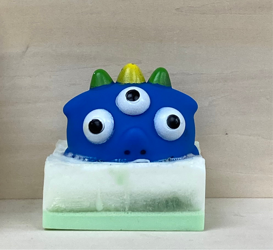 Dinosaur Squirt Toy Monster on Glow-in-the-Dark Soap
Prehistoric Bath Time Adventure!
 Price: $10
 Description:
Make bath time a roaring good time with this glow-in-the-dark glycerin soap featuring a Dinosaur Squirt Toy Monster! Infused with the tropical, fruity Monkey Farts scent, this soap turns every bath into a glowing prehistoric adventure.
Why You’ll Love It:
Dinosaur Squirt Toy Monster: A fun surprise that makes bath time exciting.
Glow-in-the-Dark Magic: Adds an extra splash of fun in the tub.