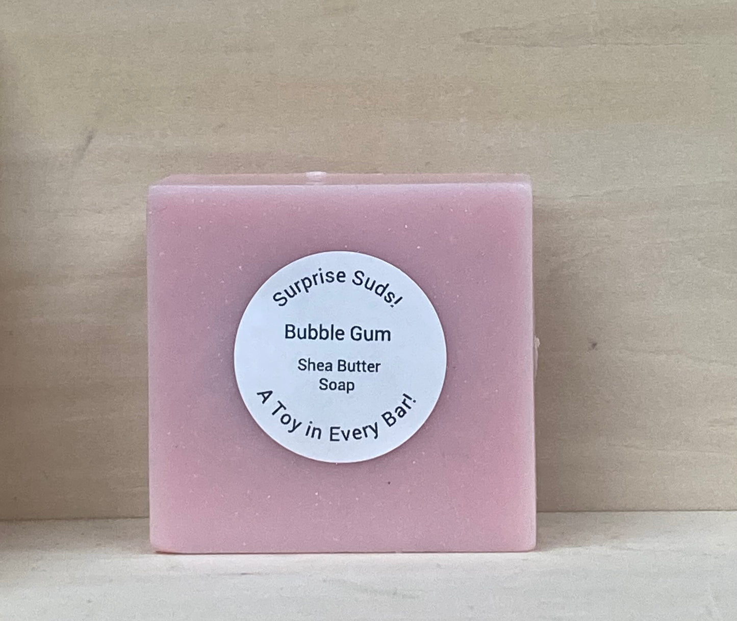 Surprise Suds – Bubble Gum Scented Shea Butter Soap
Price: $8
Turn bath time into a thrilling adventure with Surprise Suds! These vibrant oink bars aren’t just soap—they’re a treasure trove of fun, hiding a special toy inside for extra bathtime excitement!
Infused with skin-nourishing shea butter, this soap creates a rich, moisturizing lather while the Bububble Gum scent makes bathtime extra sweet! As your little one scrubs away, the excitement builds—what surprise will they uncover?
Perfect for kids (a