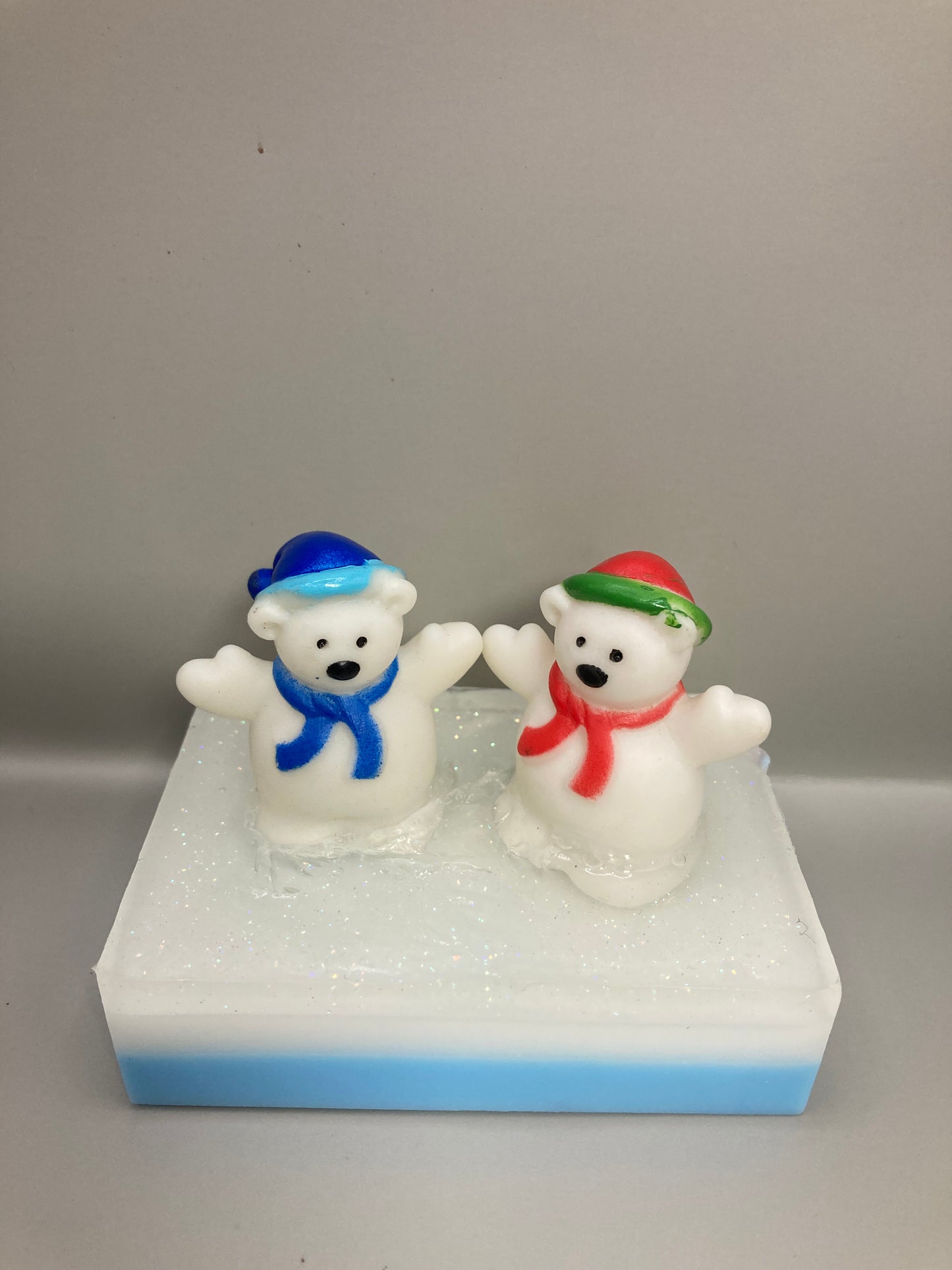 Two polar bears sit atop a bar of White Christmas scented Shea Butter and Glycerin Soap!  

This would make a perfect stocking stuffer!

 

Each item is individually made and may appear different from the photo