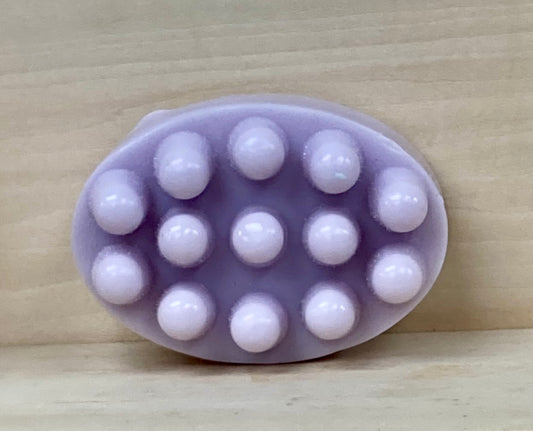 Lavender Goat’s Milk Massage Bar
Relaxation You Can Feel

Unwind with the soothing scent of lavender and the gentle touch of a massage bar. Crafted with nourishing goat’s milk, this bar is designed with rounded nubs to help ease tension while deeply moisturizing your skin. Lavender’s calming aroma makes it a timeless favorite—perfect for turning your bath or shower into a peaceful, spa-like experience.

Massage Bar Design: Gently stimulates the skin to help relax muscles and melt away stress.