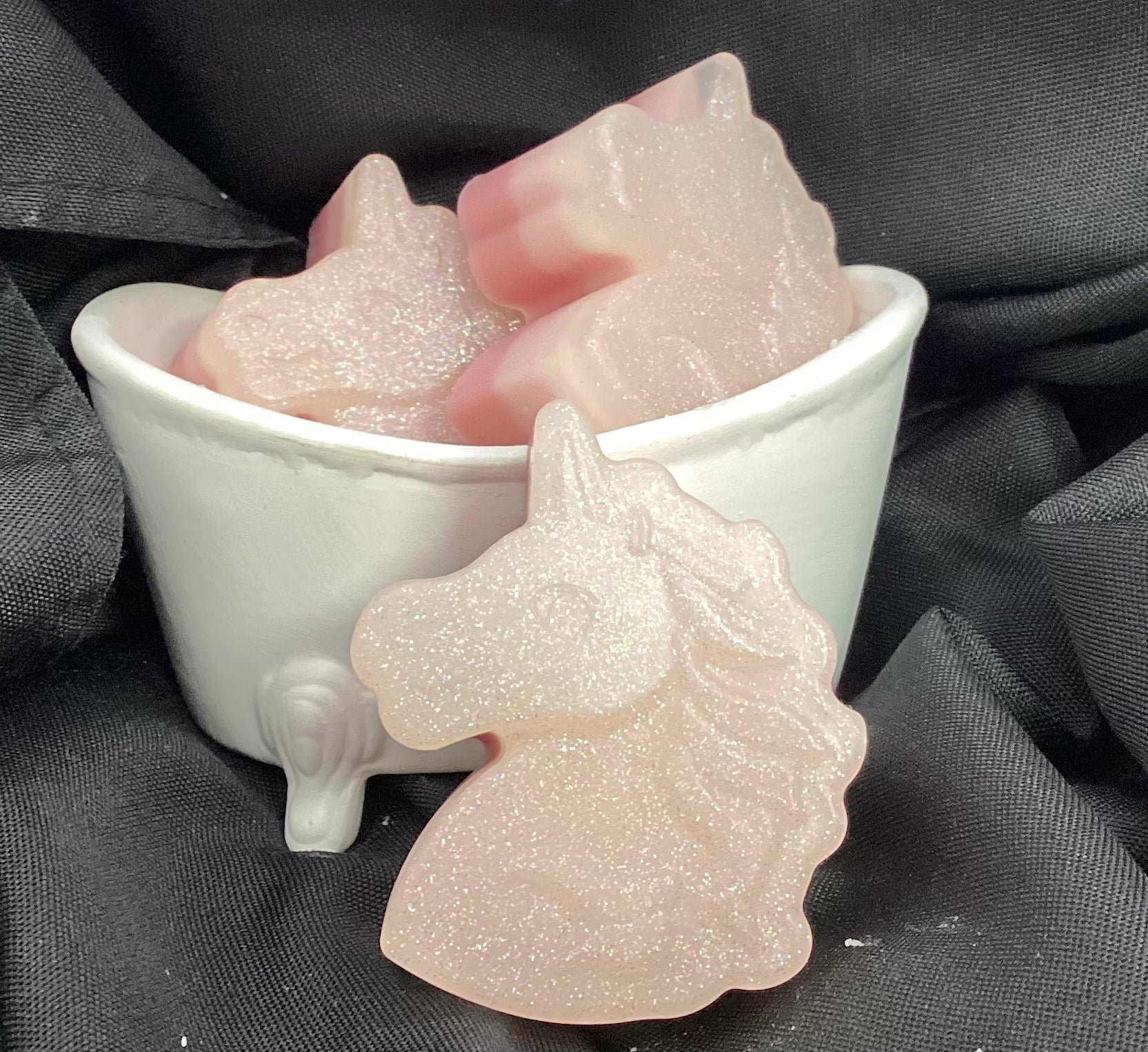 What little girl doesn't love rainbows, glitter, bubble gum, and unicorns?  This soap has it all!

This is a unicorn-shaped bar of shea butter and glycerin soap with glitter!  It even glows in the dark!   The scent is Bubble Gum.  A bar fit for your princess.

These would make a wonderful favor for a Birthday party or Baby shower.
