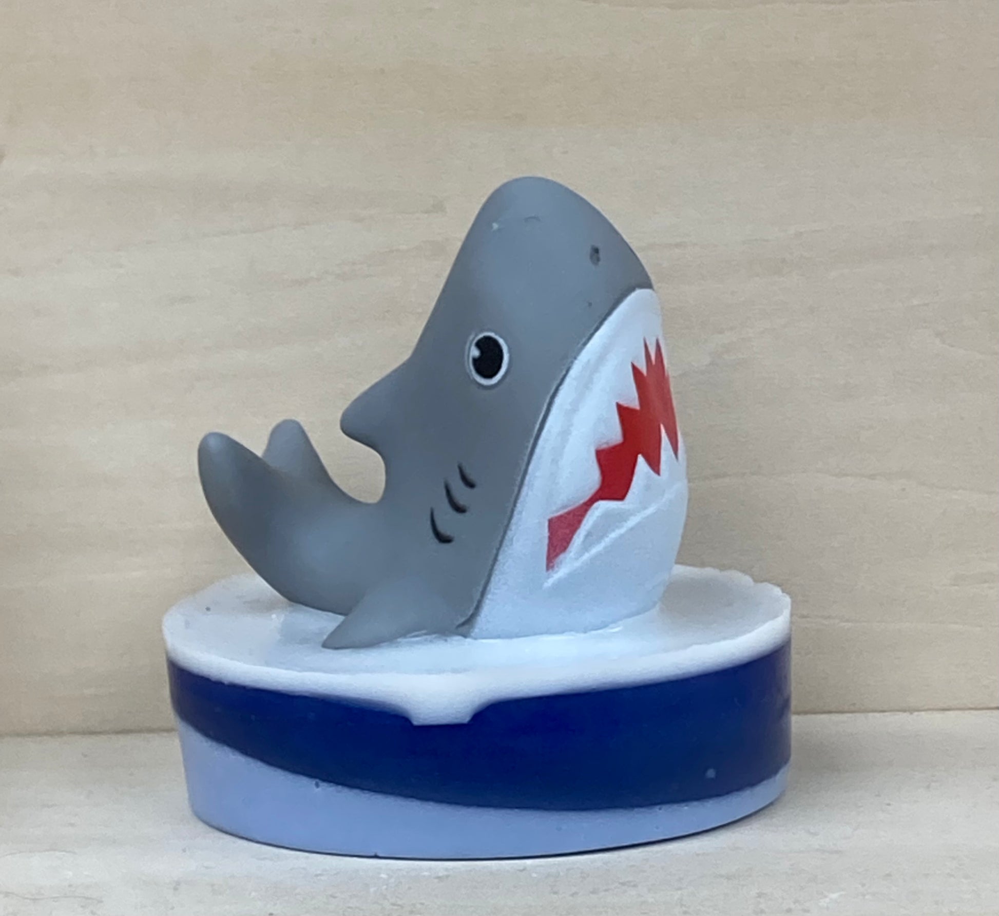 Make bath time an underwater adventure with our Shark Finger Puppet Bath Buddy! Each soap is handcrafted with skin-loving shea butter and glycerin for a rich, moisturizing lather. The playful scent of Monkey Farts (a tropical medley of banana, grapefruit, kiwi, and more) makes bath time irresistibly fun.

Features:

Includes a whimsical shark-themed story to spark imaginations during bath time.
Each soap is individually made, and the shark toy colors may vary, making every bath buddy unique.
Add a little wh