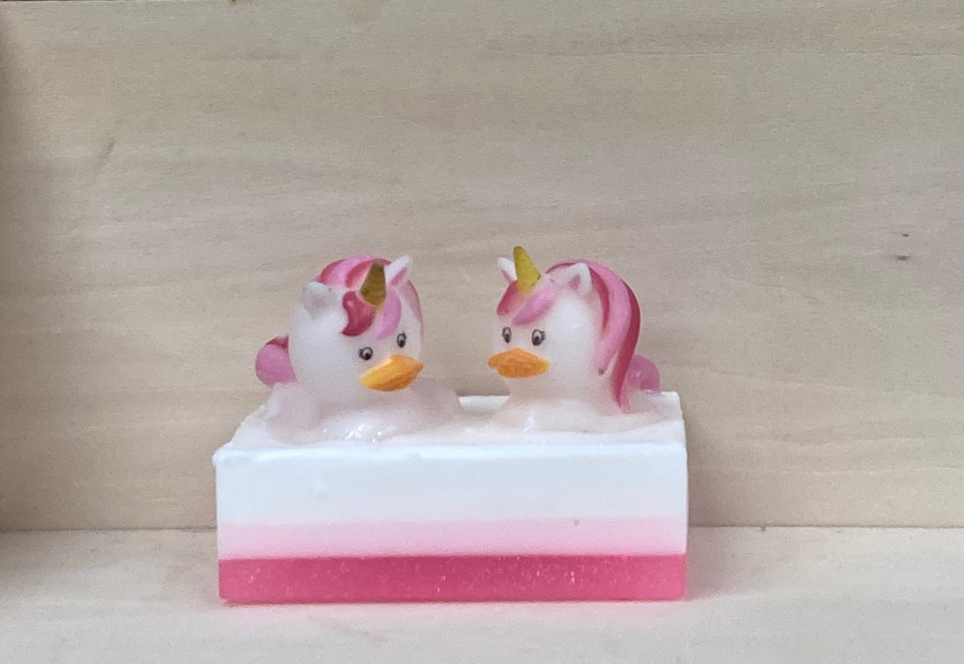 Make bath time magical with Trina and Trixie, your glittery unicorn Bath Buddies!

These sparkling, pink-maned unicorns are ready to turn your tub into the ultimate fantasy world. Scented like sweet bubble gum, Trina and Trixie sparkle atop a handcrafted bar of nourishing shea butter and glycerin soap, bringing fun and a sweet fragrance to every bath.

Features:

Handcrafted shea butter and glycerin soap
Exciting bubble gum fragrance
Playful unicorn toys with glittery pink manes
Soft and squishy texture for