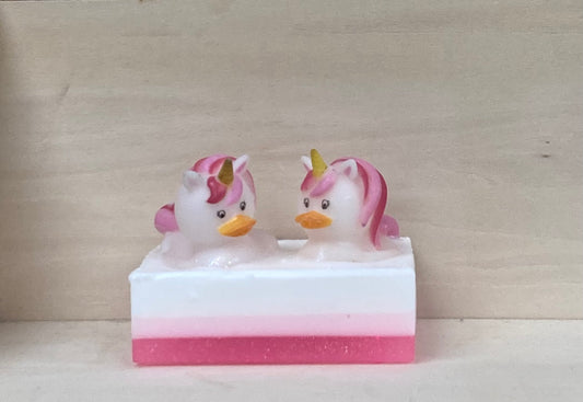 Make bath time magical with Trina and Trixie, your glittery unicorn Bath Buddies!

These sparkling, pink-maned unicorns are ready to turn your tub into the ultimate fantasy world. Scented like sweet bubble gum, Trina and Trixie sparkle atop a handcrafted bar of nourishing shea butter and glycerin soap, bringing fun and a sweet fragrance to every bath.

Features:

Handcrafted shea butter and glycerin soap
Exciting bubble gum fragrance
Playful unicorn toys with glittery pink manes
Soft and squishy texture for