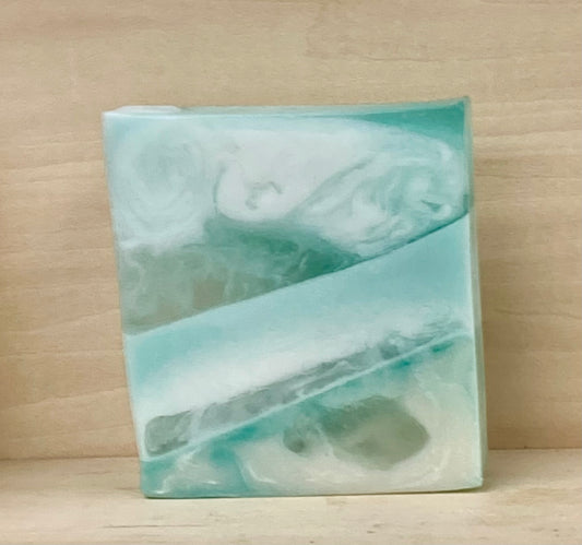 Soothing Aloe & Green Tea Goat’s Milk Soap – 4 oz
A Spa-Like Experience in Every Bar

Description:
Bring the calm of the spa to your daily routine with the refreshing scent of Soothing Aloe & Green Tea. This 4 oz bar of Goat’s Milk Soap is infused with a clean, herbal aroma that soothes the senses and pampers the skin. Perfect for a moment of tranquility, this scent combines the crisp notes of green tea with the cooling essence of aloe for a fresh, peaceful experience—like a breath of serenity