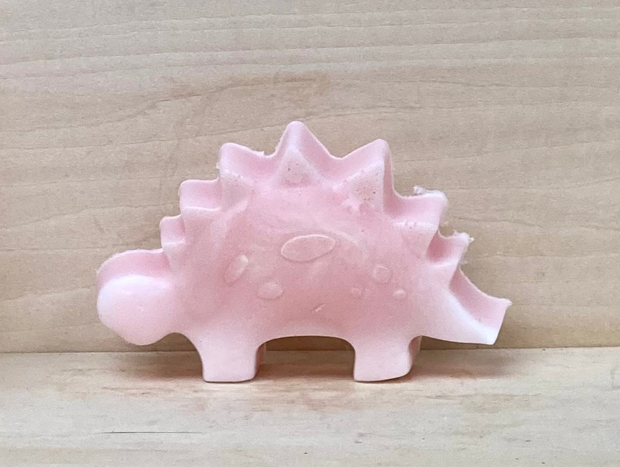 Glow-in-the-Dark Pink Dinosaur Soap – $5
Bubble Gum Scented | Goat’s Milk & Glycerin Soap

Rawr! Bath time just got a whole lot more dino-mite with these adorable glow-in-the-dark pink dinosaur soaps! Perfect for little ones (or fun-loving grownups), these playful soaps are sure to bring smiles and giggles to any sink or tub.

Scented with sweet Bubble Gum and made with a moisturizing blend of goat’s milk and glycerin, each soap is as gentle on skin as it is fun to use. 