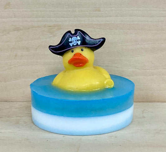 Pirate Rubber Duck Soap – $10
Shea Butter & Glycerin Soap – Ocean Breeze
Set sail for bath time adventure with this handcrafted soap featuring a rubber duck in a swashbuckling pirate hat, ready to plunder the bubbles and claim the seas (or your bathtub) as its own. Whether you’re cruising the coastline in your Jeep or relaxing with a margarita in hand, this duck brings the beach party vibe.

