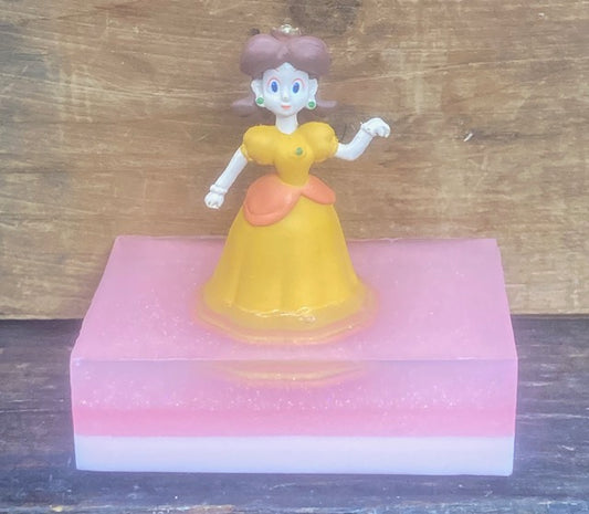 Princess Daisy Toy sits atop a bar of Bubble Gum scented Shea Butter and Glycerin soap.   $8  Each item is individually made and may appear different from the photo.