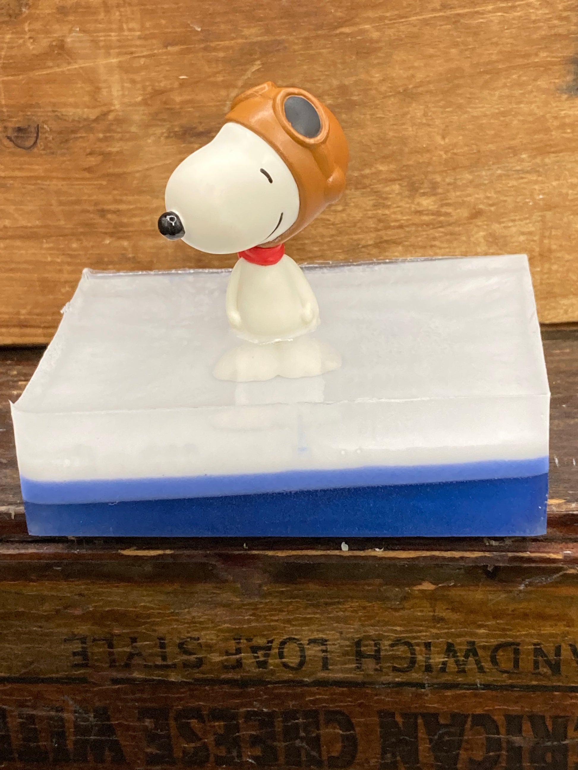 Who doesn't love Snoopy?  This is a Snoopy toy on a Bar of Bubble Gum scented Shea Butter and Glycerin Soap.